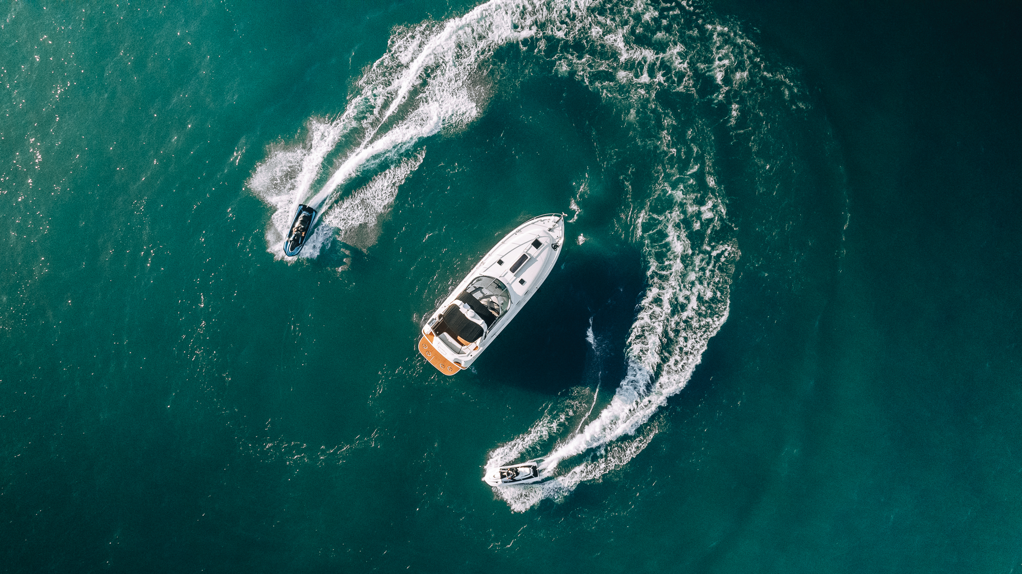 Aerial view of a Sea Ray yacht carving a wake on Lake Michigan